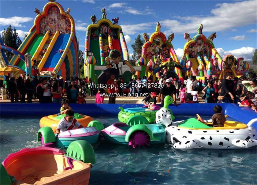 Kids riding real shot of paddle boat at outdoor lake carnival water zone (1).jpg