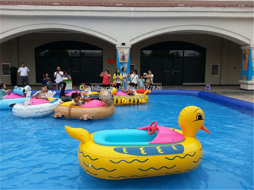 Kids driving electric bumper boat at outdoor lake carnival water zone (4).jpg