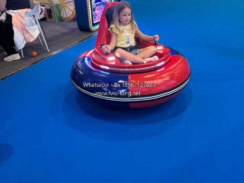 Kids interactive playing scene of electric bumper car at mall playground.jpg