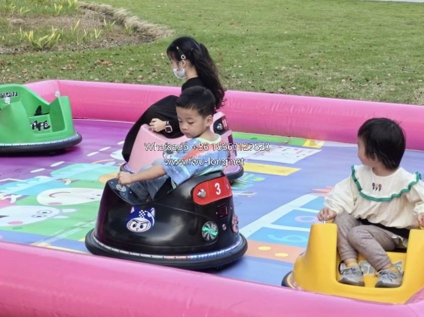 Kids playing mini bumper car at indoor mall family playground.jpg